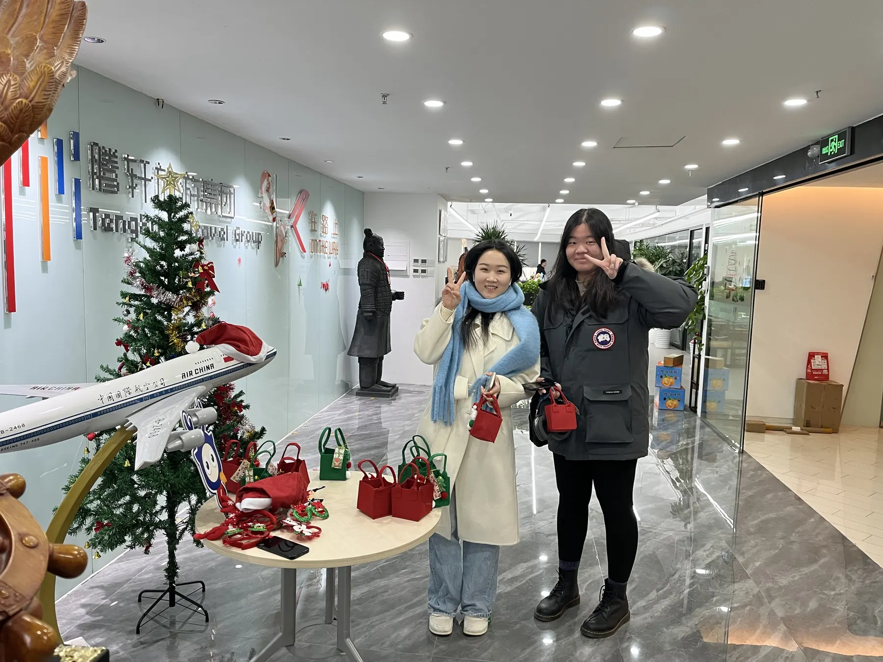 Two team members visiting Tengxuan office during a festive season