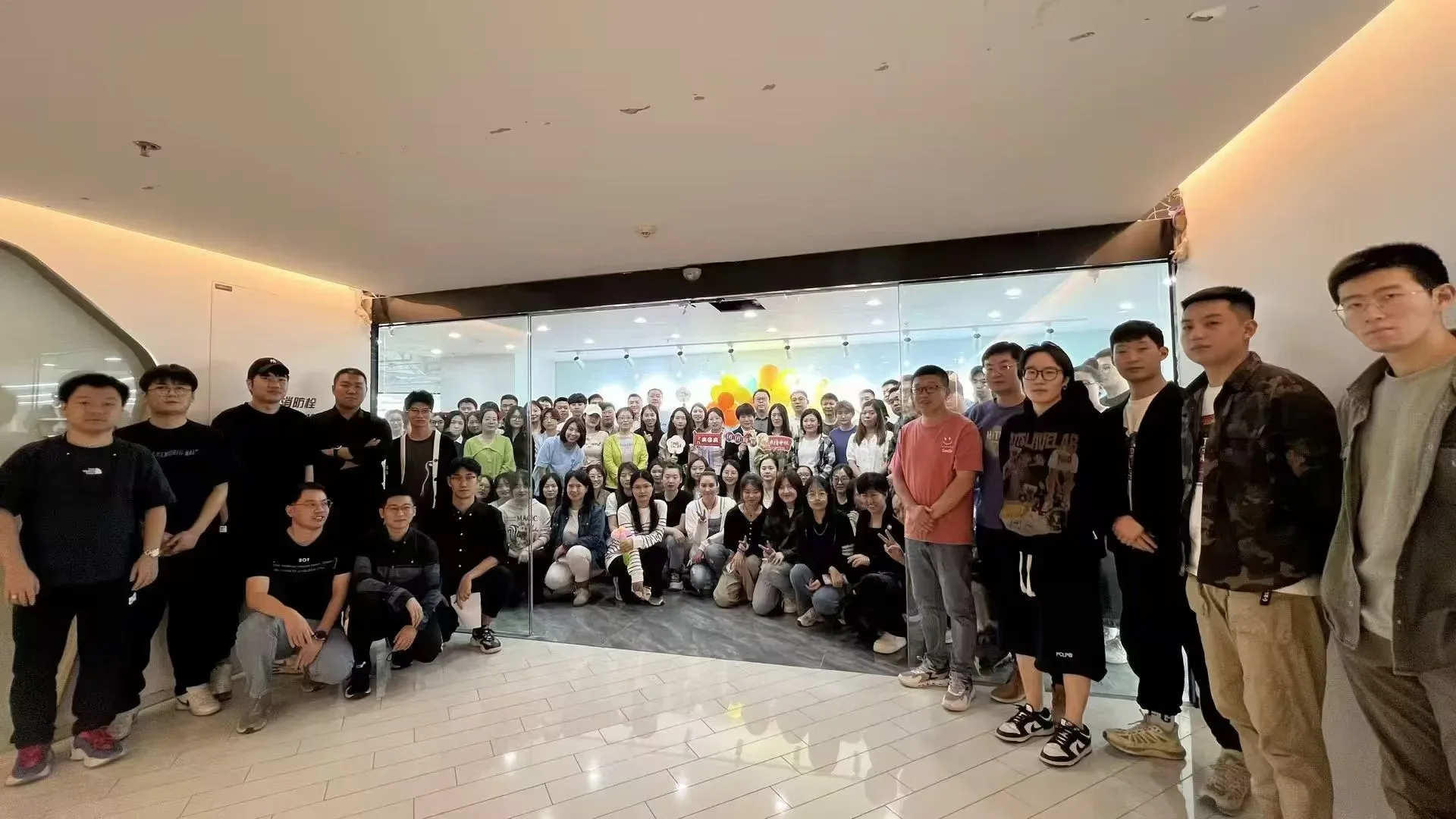 Tengxuan Travel team group photo inside an office